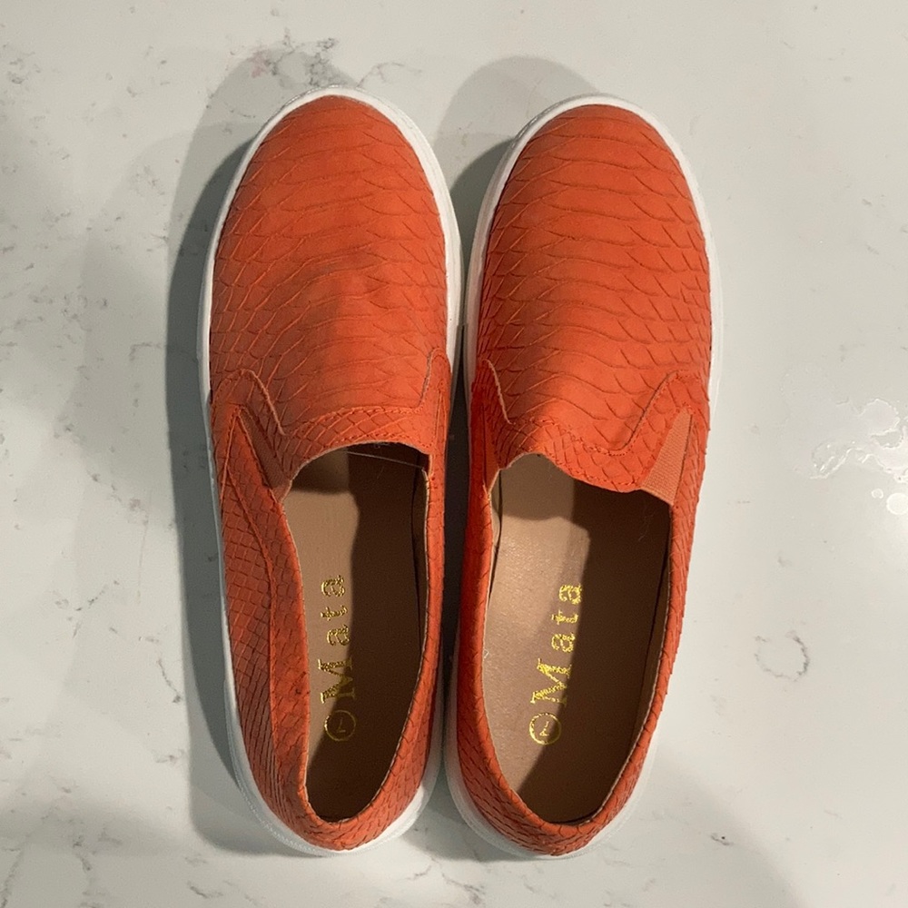 Orange textured slip on sneakers